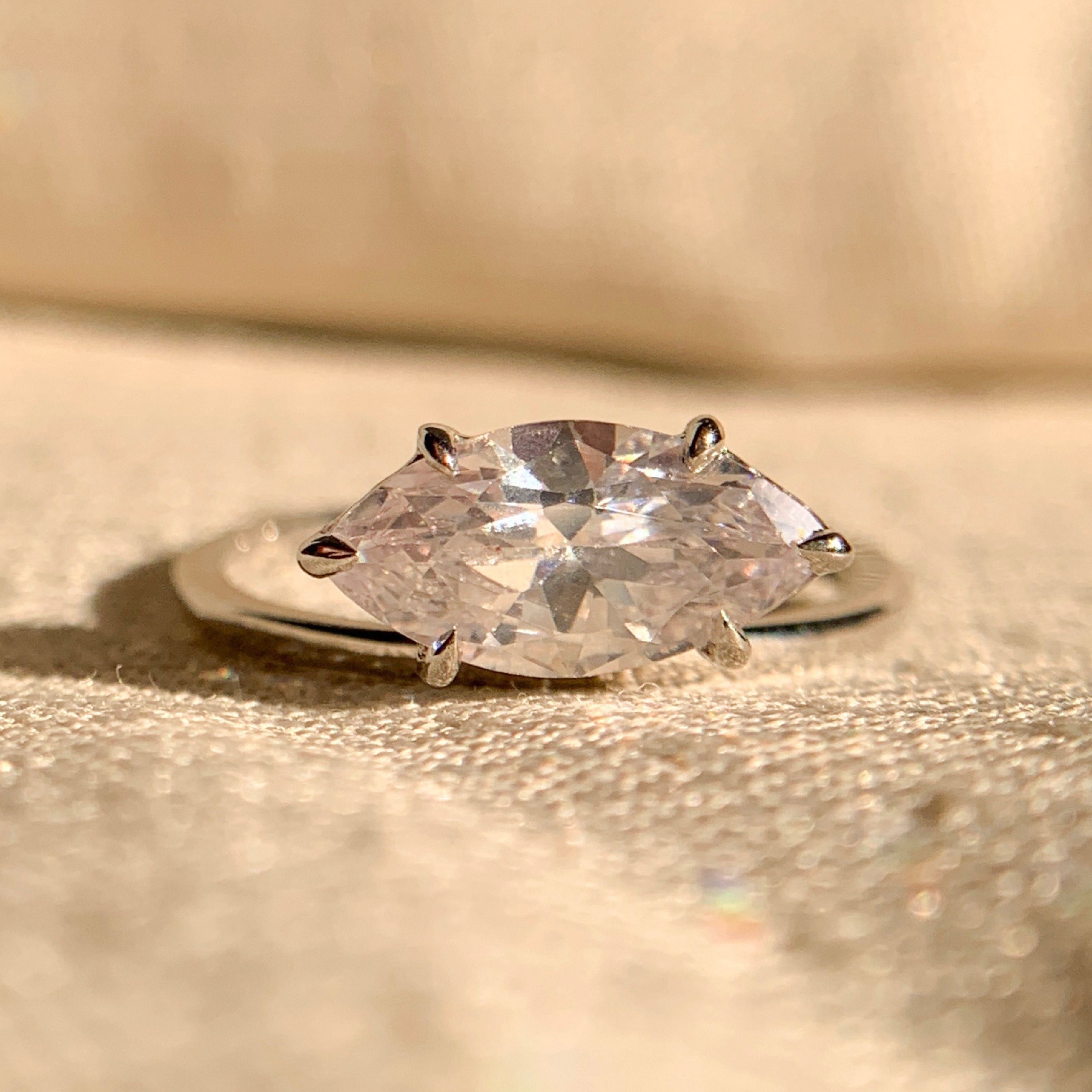 Curved women’s wedding band designed to fit pear shaped engagement ring